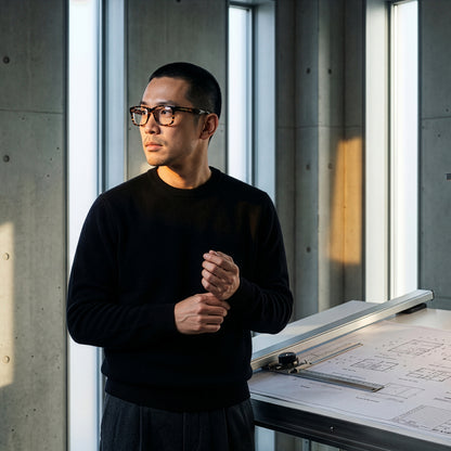 Person wearing SonaVue K-Man tortoiseshell audio glasses in an architecture studio